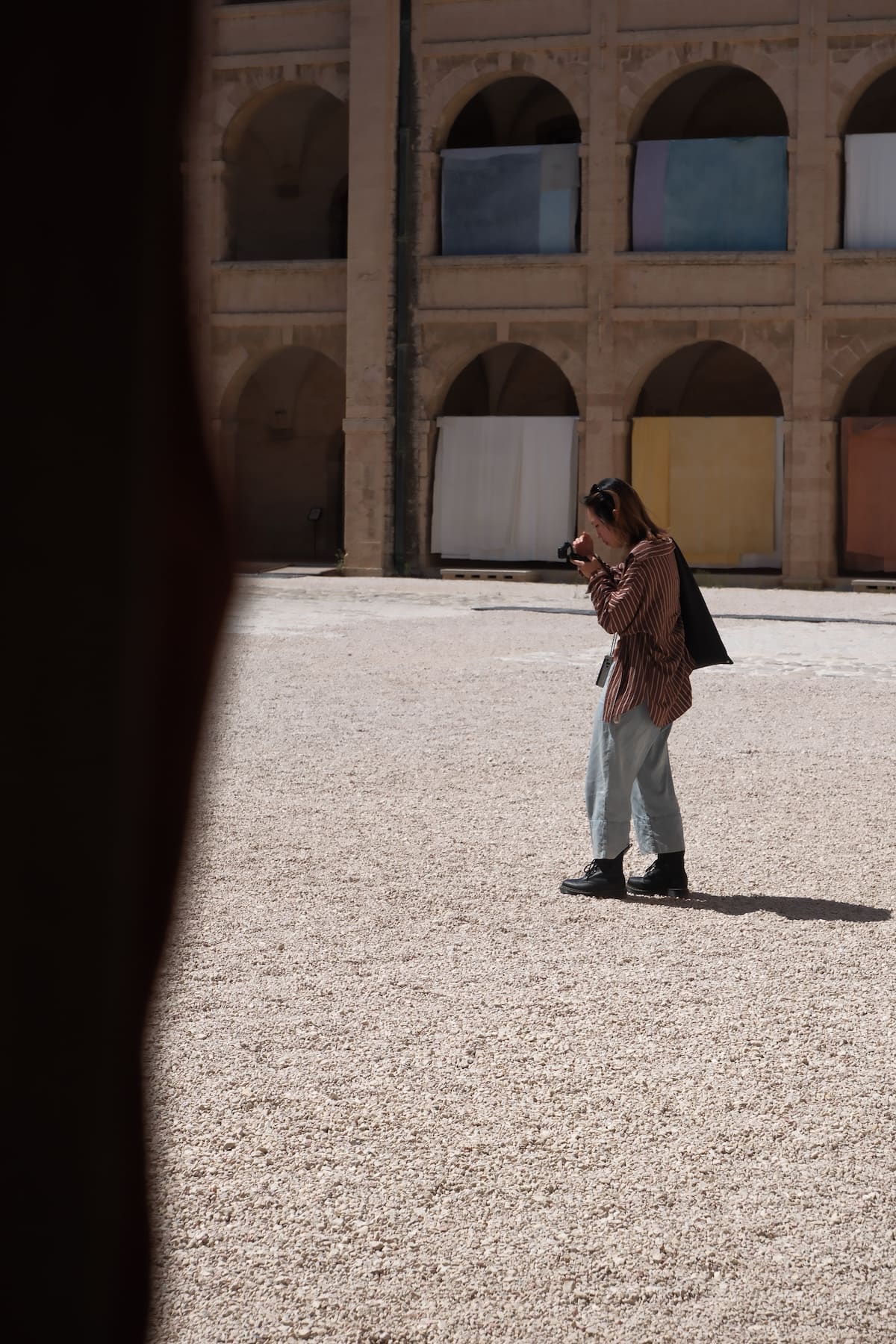 Person with a camera in a courtyard